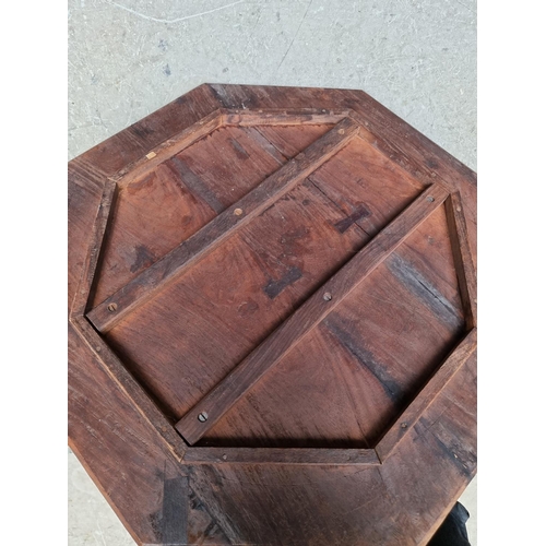 1035 - An Indian carved and pierced hardwood octagonal folding table, 61cm wide. 