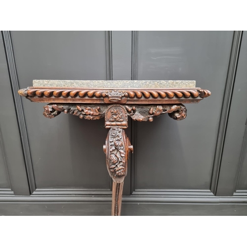 1036 - An interesting 19th century carved oak console table, with green marble top above a gadrooned frieze... 