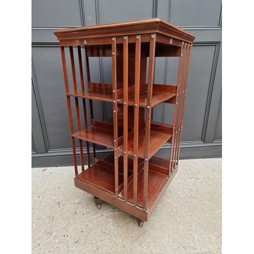 1037 - A large circa 1900 mahogany revolving bookcase, 120.5cm high x 59cm wide.