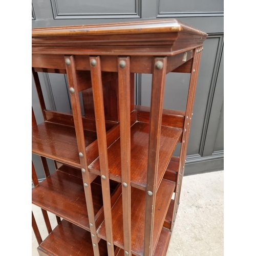 1037 - A large circa 1900 mahogany revolving bookcase, 120.5cm high x 59cm wide.