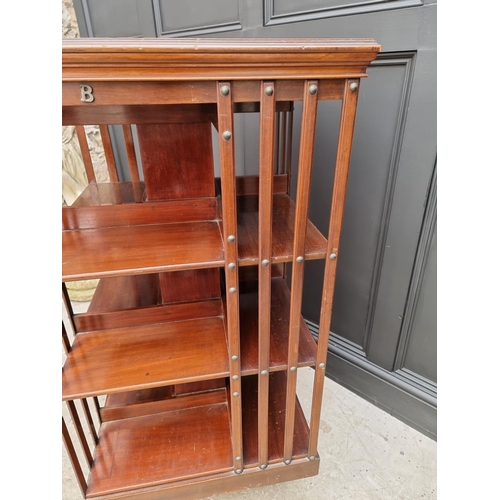 1037 - A large circa 1900 mahogany revolving bookcase, 120.5cm high x 59cm wide.