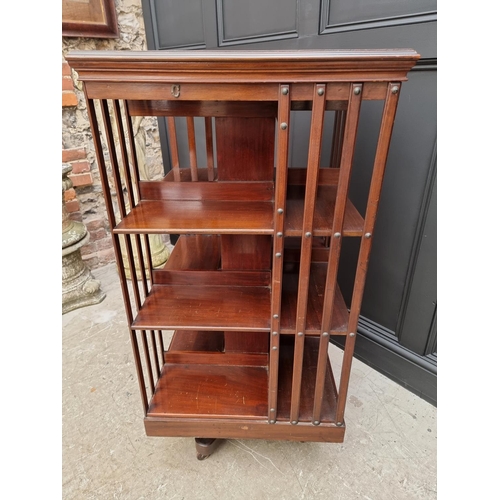 1037 - A large circa 1900 mahogany revolving bookcase, 120.5cm high x 59cm wide.