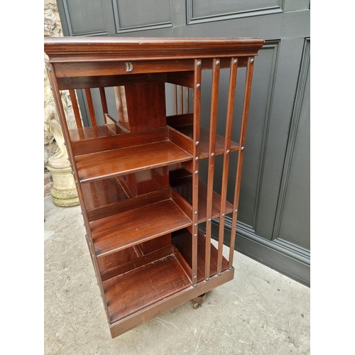 1037 - A large circa 1900 mahogany revolving bookcase, 120.5cm high x 59cm wide.