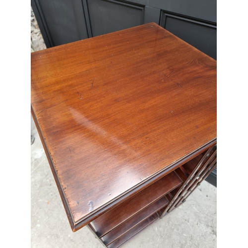 1037 - A large circa 1900 mahogany revolving bookcase, 120.5cm high x 59cm wide.