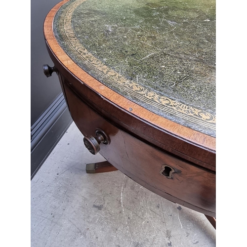 1041 - A small George III and later mahogany drum top library table, with leather inset surface above ... 