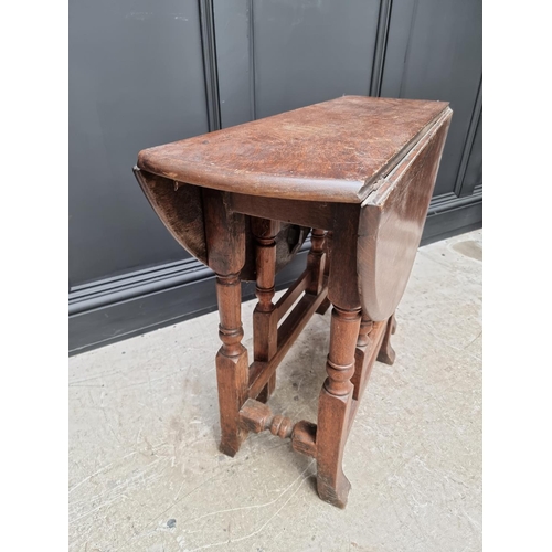 1050 - An antique oak gateleg table, 89cm wide. 