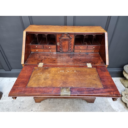 1051 - A George III mahogany and crossbanded bureau, 92.5cm wide. 