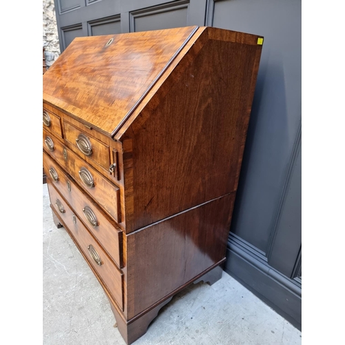 1051 - A George III mahogany and crossbanded bureau, 92.5cm wide. 