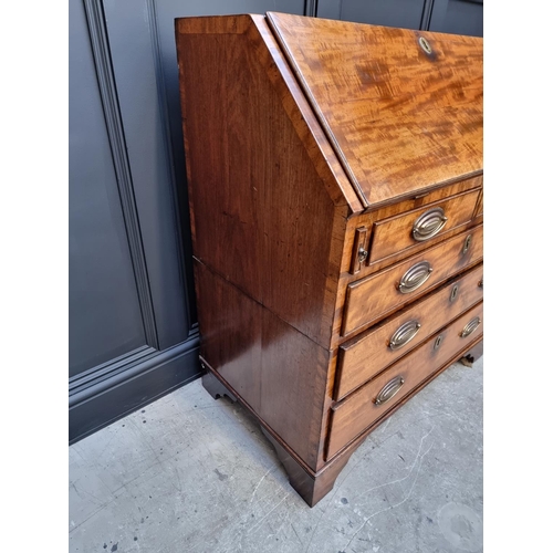 1051 - A George III mahogany and crossbanded bureau, 92.5cm wide. 