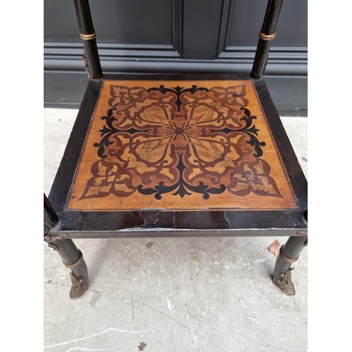 1056 - An unusual late 19th century Egyptian revival ebonized and inlaid occasional table, the top inset wi... 