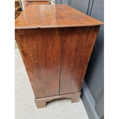 1058 - An 18th century oak three drawer chest, with moulded frieze, 89.5cm wide. 