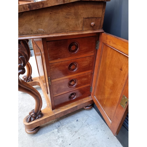 1062 - A Victorian figured walnut Davenport, 53.5cm wide.