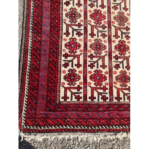 1011 - A Persian rug, having repeated geometric design to central field, with geometric borders, 186 x 94cm... 