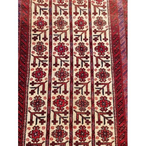 1011 - A Persian rug, having repeated geometric design to central field, with geometric borders, 186 x 94cm... 