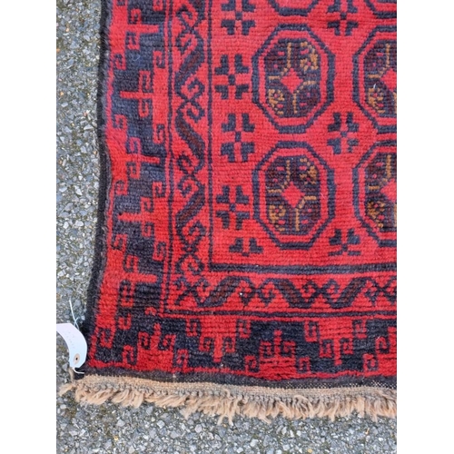 1012 - A Persian rug, having repeated decoration to central field, with geometric borders, 144 x 92cm.... 