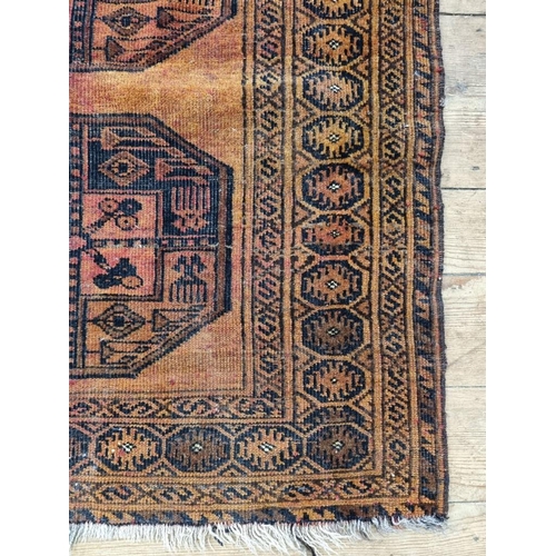 1013 - A small Afghan rug, on an orange ground, with two central medallions, 115 x 90cm.