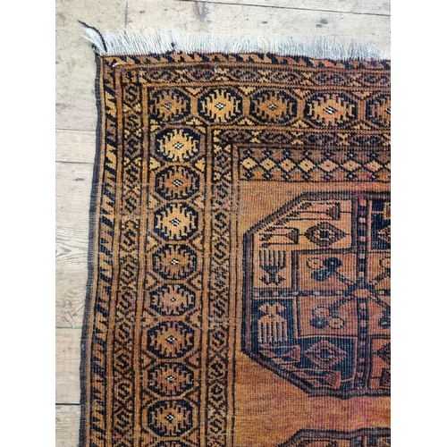 1013 - A small Afghan rug, on an orange ground, with two central medallions, 115 x 90cm.