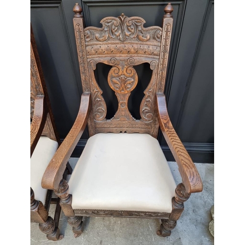 1017 - A pair of late Victorian carved oak open armchairs, with studded cream leather seats.... 