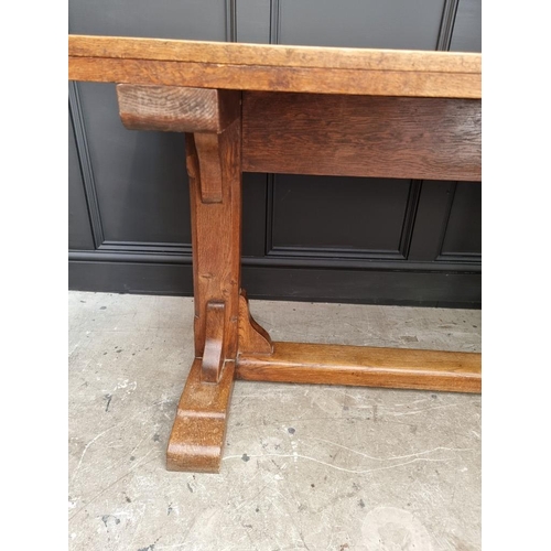 1023 - An oak trestle table, on chamfered supports, 152.5cm long.