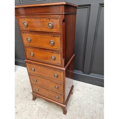 1028 - A small reproduction mahogany chest on chest, 48cm wide. 