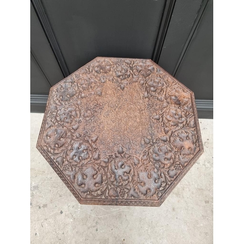 1035 - An Indian carved and pierced hardwood octagonal folding table, 61cm wide. 