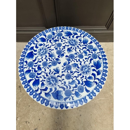 1039 - A blue and white porcelain conservatory pedestal table, 42cm high x 52cm diameter. ... 