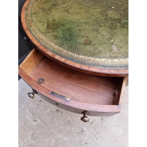 1041 - A small George III and later mahogany drum top library table, with leather inset surface above ... 