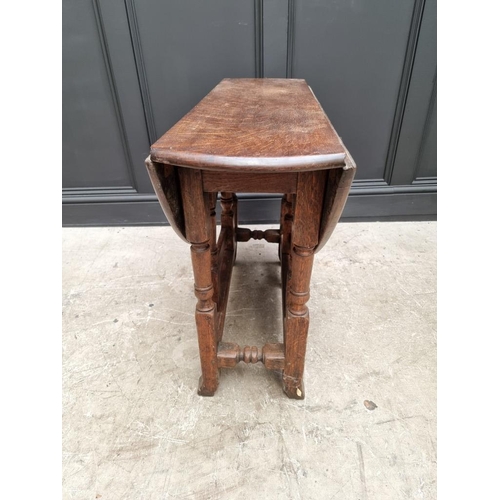 1050 - An antique oak gateleg table, 89cm wide. 