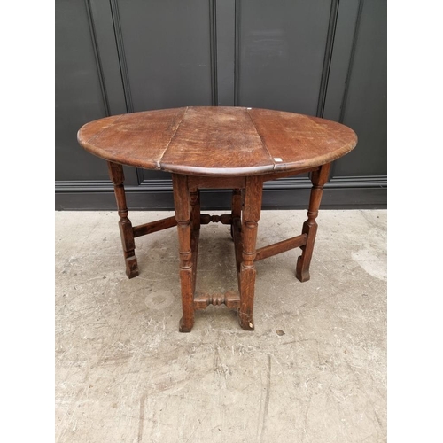 1050 - An antique oak gateleg table, 89cm wide. 