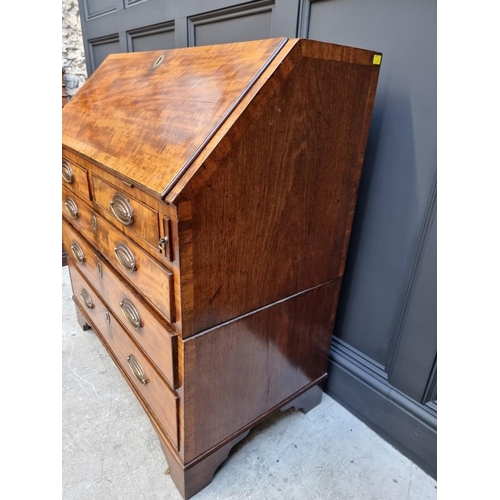 1051 - A George III mahogany and crossbanded bureau, 92.5cm wide. 