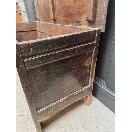 1053 - A 17th century oak panelled coffer, with unusual carved frieze, 138cm wide. 