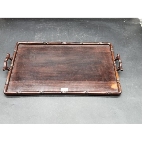 1054 - A Chinese carved hardwood twin handled rectangular tray, with simulated bamboo decoration, 57cm wide... 