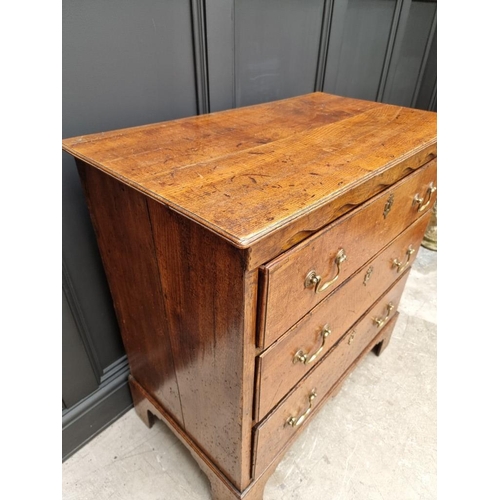 1058 - An 18th century oak three drawer chest, with moulded frieze, 89.5cm wide. 