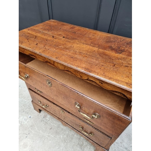 1058 - An 18th century oak three drawer chest, with moulded frieze, 89.5cm wide. 