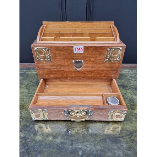 1059 - A Victorian oak and brass mounted stationary casket, 31cm wide. 