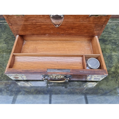 1059 - A Victorian oak and brass mounted stationary casket, 31cm wide. 