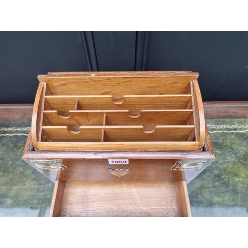 1059 - A Victorian oak and brass mounted stationary casket, 31cm wide. 