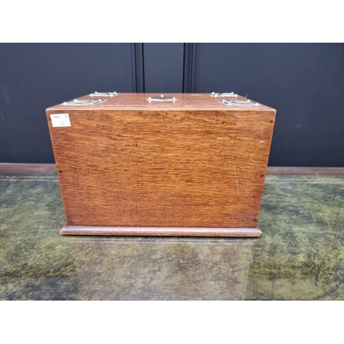 1059 - A Victorian oak and brass mounted stationary casket, 31cm wide. 