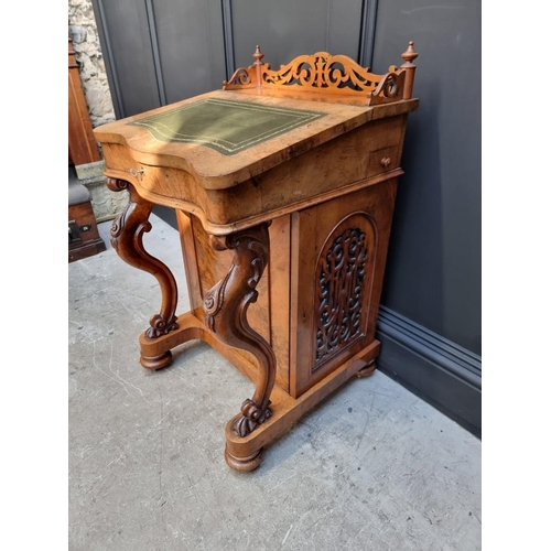 1062 - A Victorian figured walnut Davenport, 53.5cm wide.