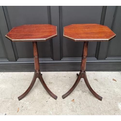 1071 - A pair of mahogany tripod tables, with brass edged octagonal tops, 40.5cm wide.