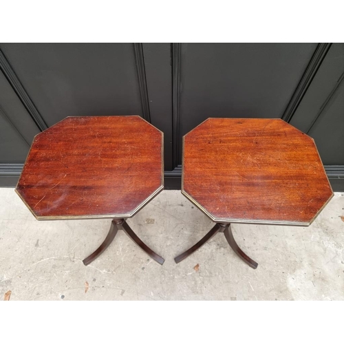 1071 - A pair of mahogany tripod tables, with brass edged octagonal tops, 40.5cm wide.