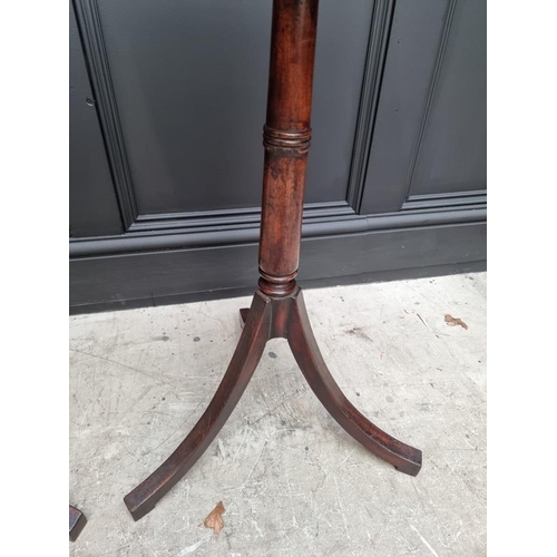 1071 - A pair of mahogany tripod tables, with brass edged octagonal tops, 40.5cm wide.