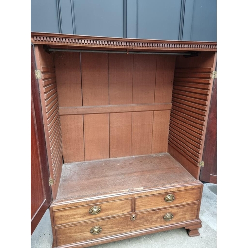 1072 - A small George III mahogany linen press, possibly Channel Islands, Guernsey, enclosing hanging space... 