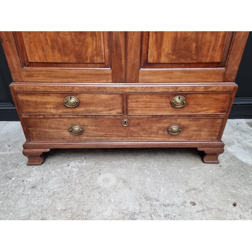 1072 - A small George III mahogany linen press, possibly Channel Islands, Guernsey, enclosing hanging space... 