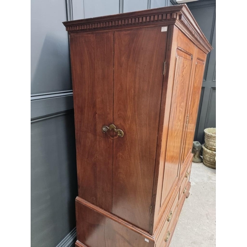 1072 - A small George III mahogany linen press, possibly Channel Islands, Guernsey, enclosing hanging space... 