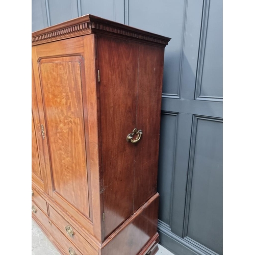 1072 - A small George III mahogany linen press, possibly Channel Islands, Guernsey, enclosing hanging space... 