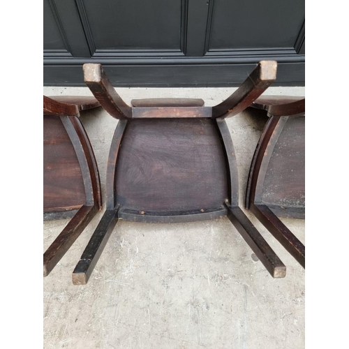 1075 - An interesting set of three George III shield back hall chairs, each with painted lion crest to back... 