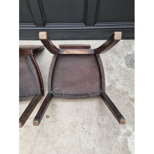 1075 - An interesting set of three George III shield back hall chairs, each with painted lion crest to back... 