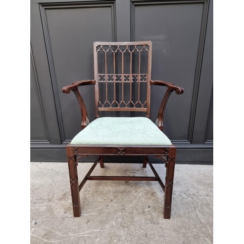 1076 - A late 19th/early 20th century Gothic style mahogany elbow chair; together with another mahogan... 