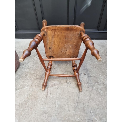 1077 - A Victorian ash, elm and beech lath back elbow chair. 